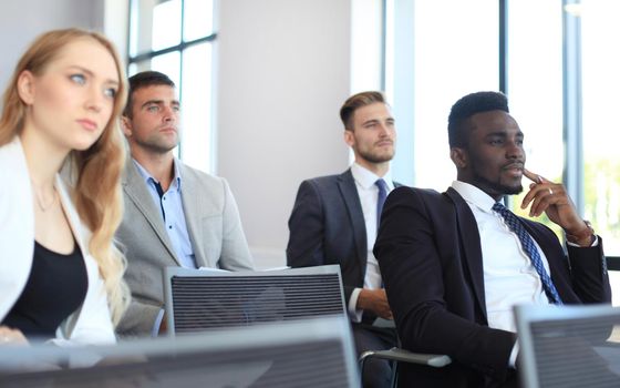 Group of businessmen sitting in conference to speech while having business meeting.