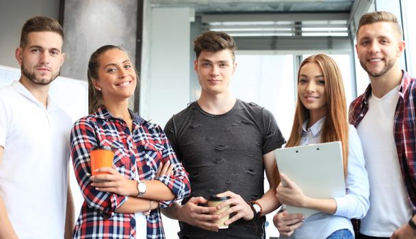 Group portrait of happy young colleagues in the office