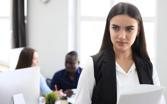 business woman with her staff, people group in background at modern bright office indoors