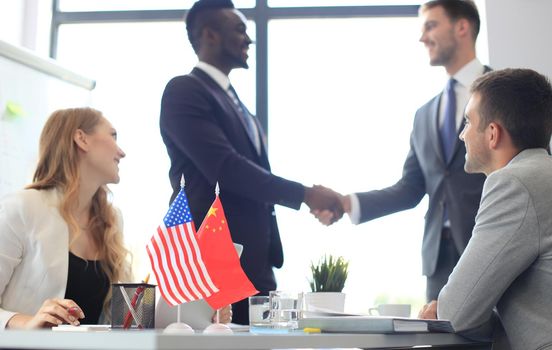 Chinese and American leaders shaking hands on a deal agreement.