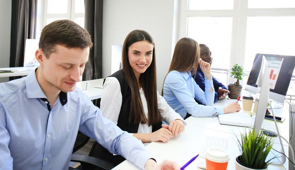 Coworking process, designers team work project. Photo young business crew working with new startup modern office