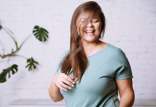 Portrait of the happy plus size model 