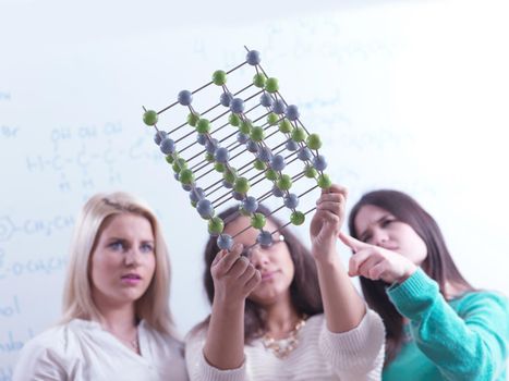 happy young teens group in school on chemisty lessons and library education