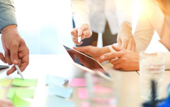 Coworkers discussing the financial status of their business on a digital tablet