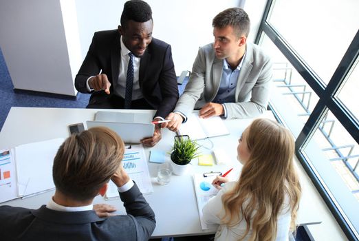 Businessman with colleagues in the background in office