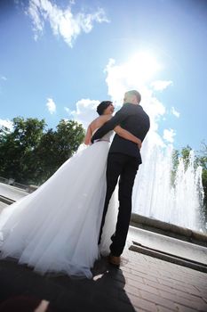 rear view. happy bride and groom on the background of the town square.photo with copy space