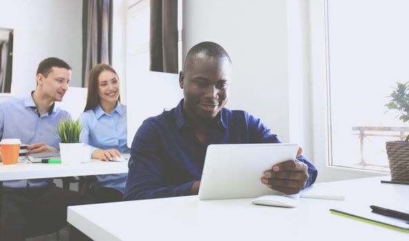 Handsome Afro American businessman working in office