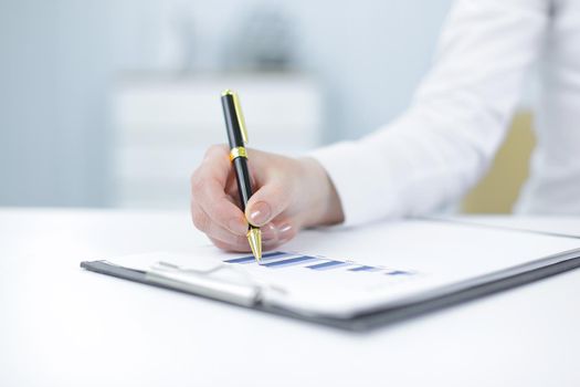 closeup.business woman analyzing the financial schedule .photo with copy space