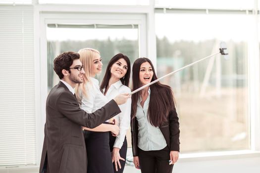 members of a successful business team is doing a selfie in the lobby of the modern office