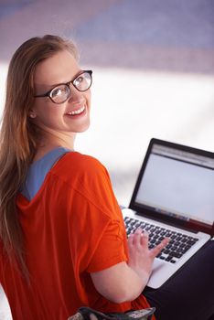 happy student girl working on laptop computer at modern school university indoors