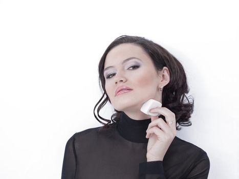 beautiful young woman doing make-up. isolated on a white background