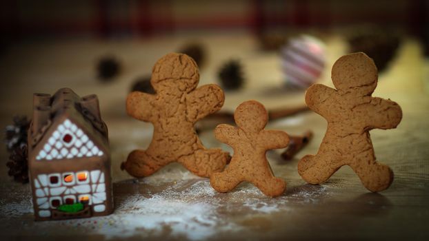 gingerbread house gingerbread men on blurred background of the table.photo with copy space