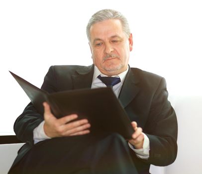 close up.handsome businessman with a clipboard,sitting in an office chair