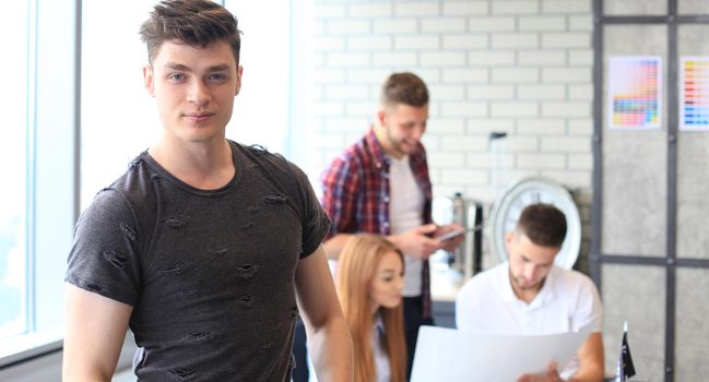 Businessman with colleagues in the background in office