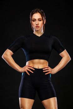 Sporty and fit woman doing exercising at black background to stay fit.