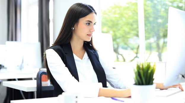 Modern business woman in the office with copy space.