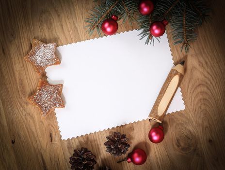 blank Christmas card and ornaments on wooden background. place for text