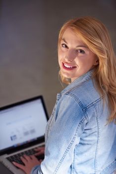 happy student girl working on laptop computer at modern school university indoors