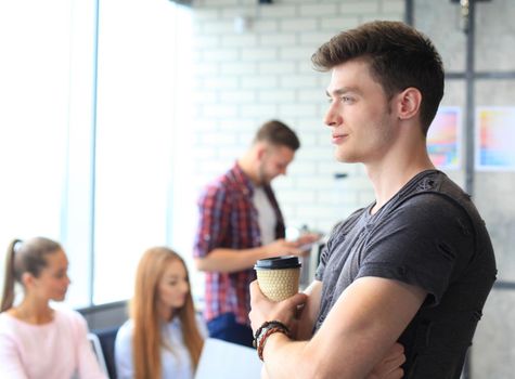 Businessman with colleagues in the background in office