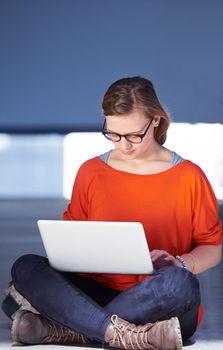 happy student girl working on laptop computer at modern school university indoors