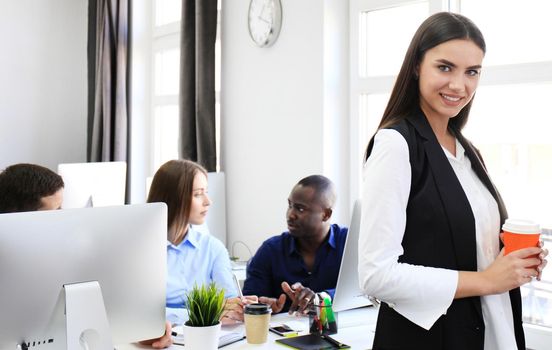 business woman with her staff, people group in background at modern bright office