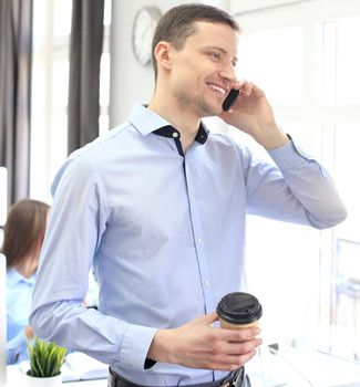 Businessman talk to cellphone and look out of window