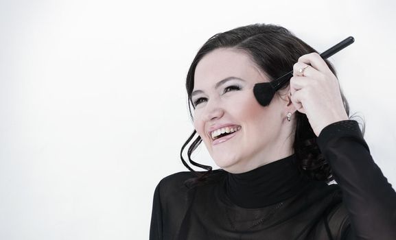 smiling young woman with brush for makeup.photo with copy space