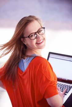 happy student girl working on laptop computer at modern school university indoors