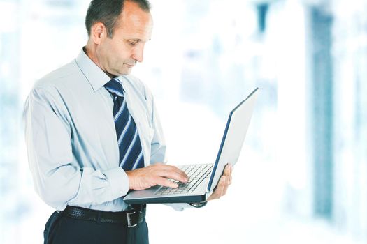 close-up of a businessman who deals on the Internet on the laptop. photo blurred background and has an empty space for your text