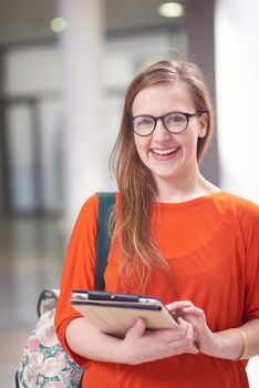 happy student girl working on tablet computer at modern school university indoors