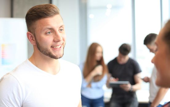 Businessman with colleagues in the background in office