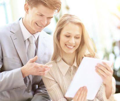 close up.smiling business couple with digital tablet.people and technology