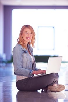 happy student girl working on laptop computer at modern school university indoors