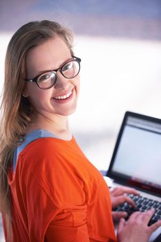 happy student girl working on laptop computer at modern school university indoors