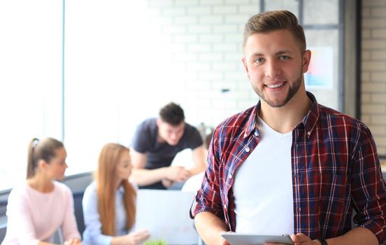 Businessman with colleagues in the background in office