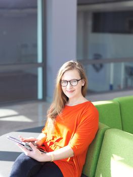 happy student girl working on tablet computer at modern school university indoors