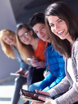 students group working on school  project  together on tablet computer  at modern university