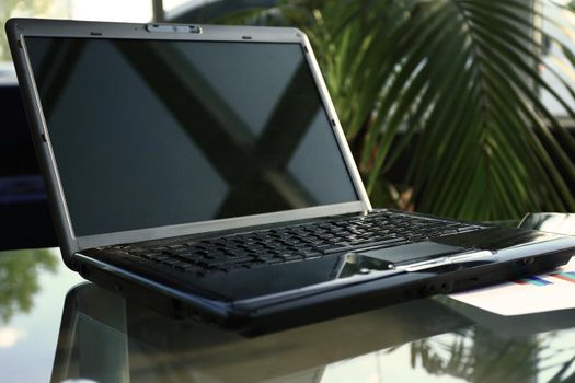 Closeup photo of laptop computer with open top. Blank screen