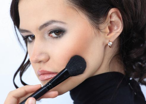 smiling young woman with brush for makeup.photo with copy space