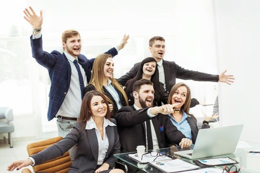 closeup of triumphant business team near the desktop, on the background of the office