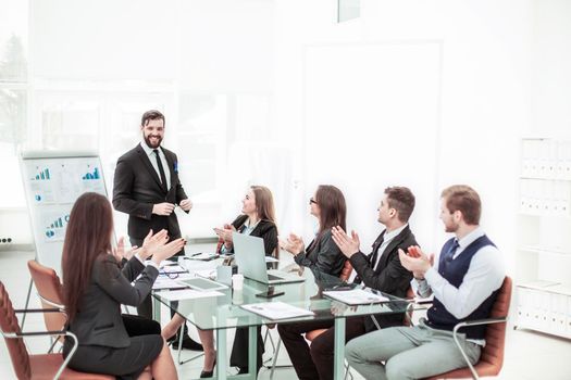 successful business team applauding the Manager Finance on the presentation of the new project in the workplace in the office