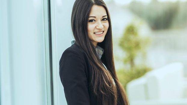 young prospective female employee on the background of a large window in the office