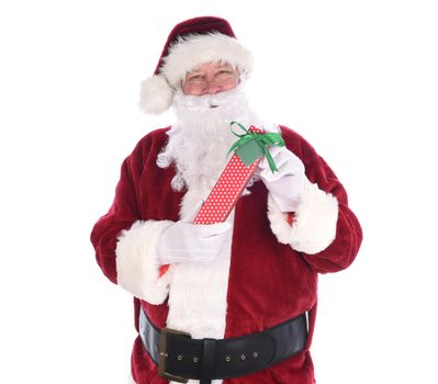 Santa holidng a polka dot paper wrapped Christmas Present, isolated on white.