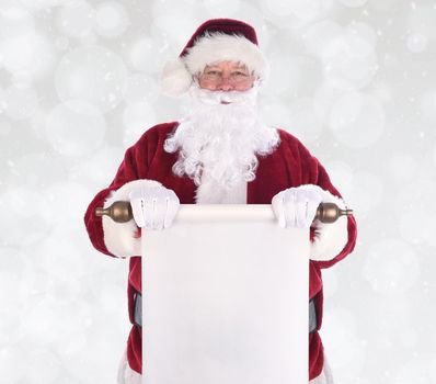 Santa Claus holding a scroll of paper in front of his body, over a boheh background with snow effect. The paper is blank with room for your copy.