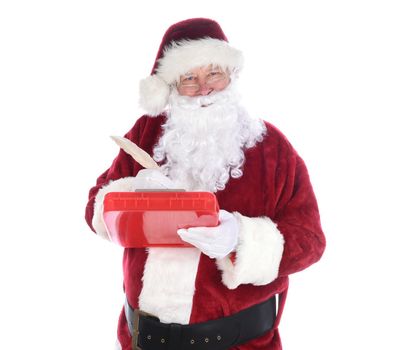 Santa Claus holding a clipboard holding aqill pen making notes on his naughty and nice list. isolated on white.