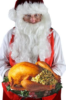 Santa Claus serving a fresh Roasted Thanksgiving or Christmas Turkey with all the trimmings. 