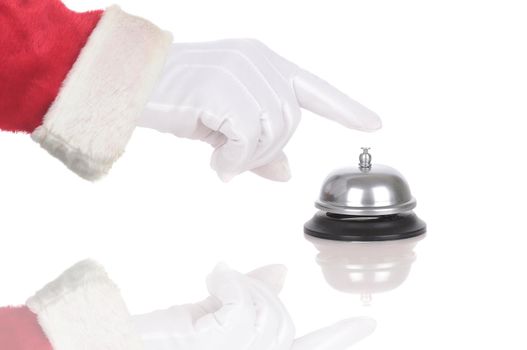 Santa Claus gloved hand extended over service bell isolated on white. Hand and arm only in horizontal format with reflection.