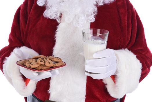 Closeup of Santa Claus holding a plate of chocolate chip cookies and a glass of milk.