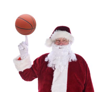 Santa Claus with his index finger pointing up with a basketball balanced on the tip, isolated on white.