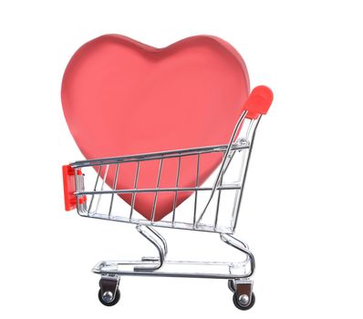 Valentines Day Concept. A large heart shaped candy box inside a grocery shopping cart, isolated on white. 
